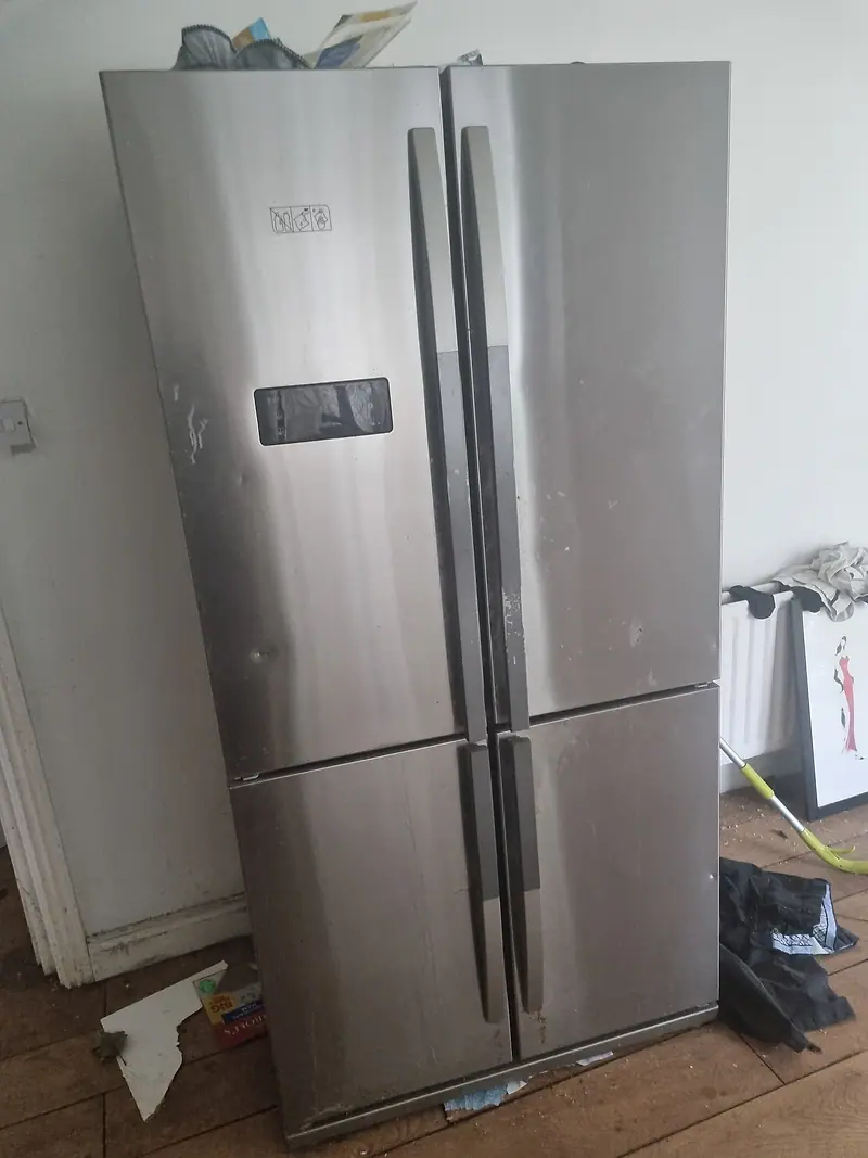 Large American-style fridge freezer awaiting removal