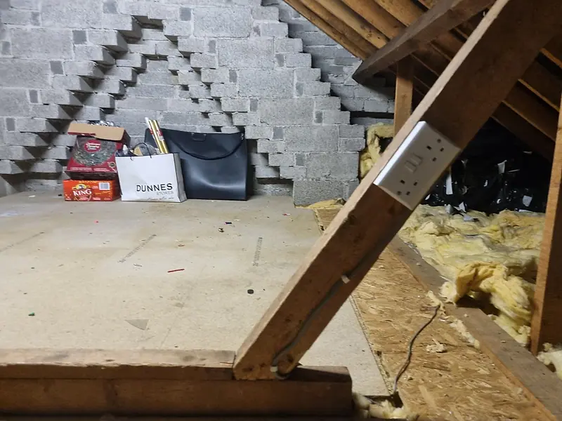 The same attic cleared back to the boarded deck and roof timbers