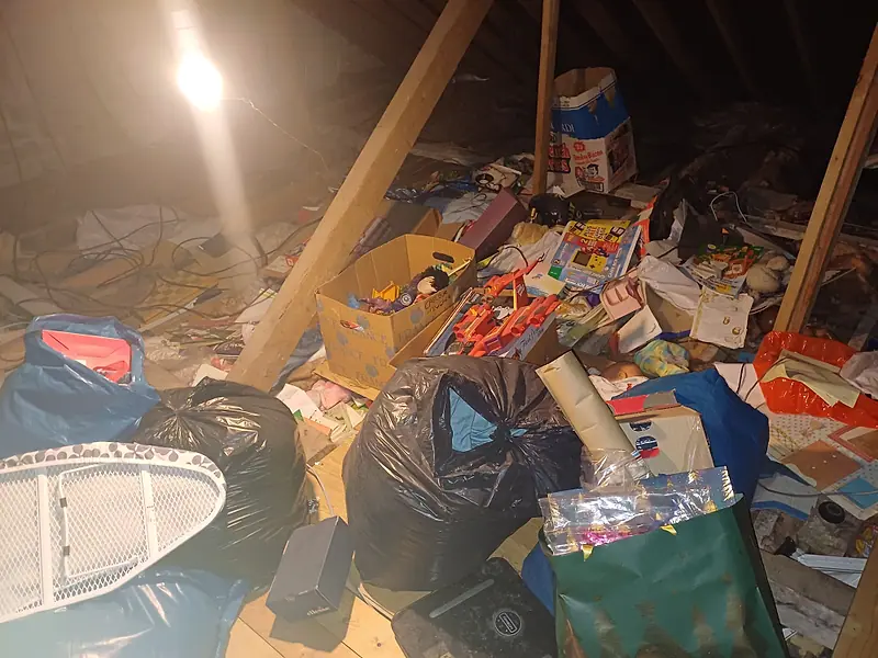 Attic floor covered with bags, boxes and toys before clearance