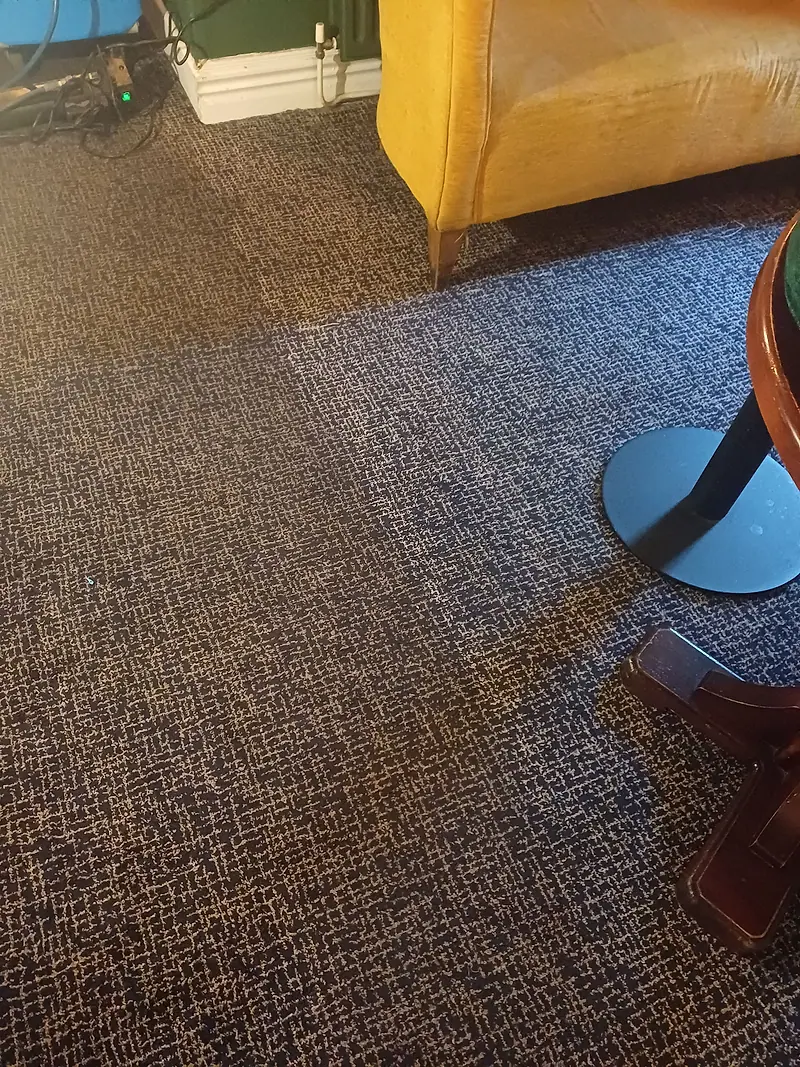 Patterned commercial carpet in a bar area showing a clear clean line