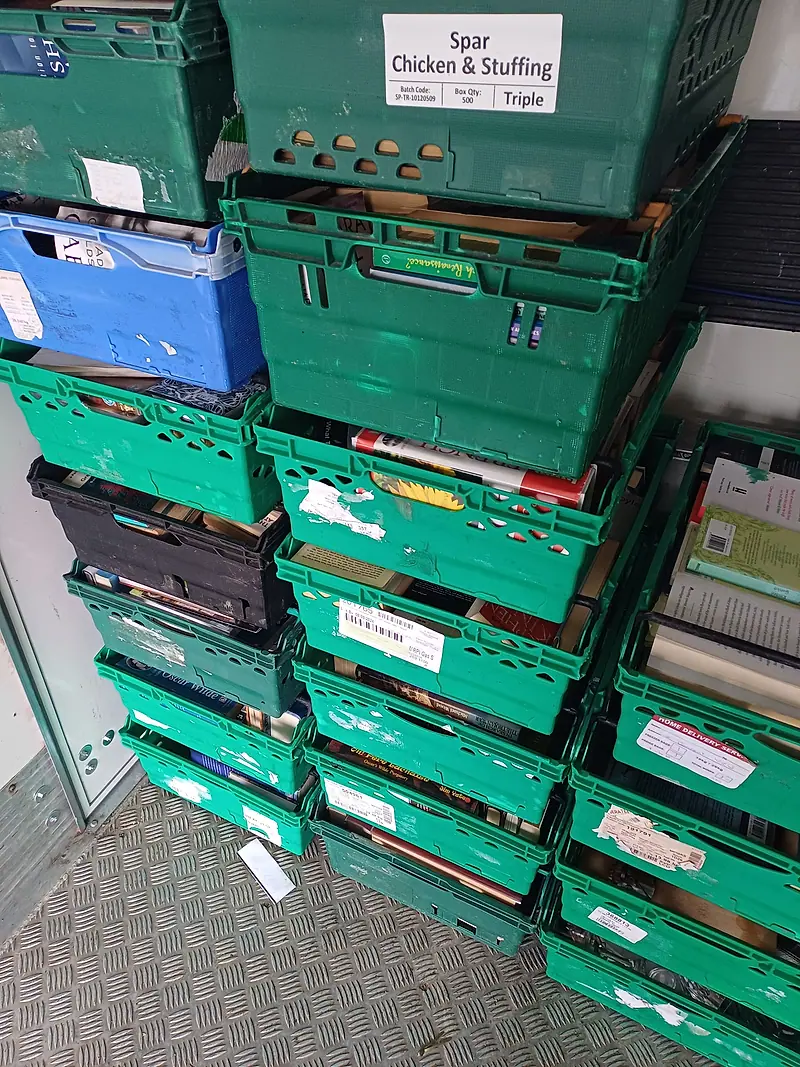 Stacked crates of books loaded in our van for reuse