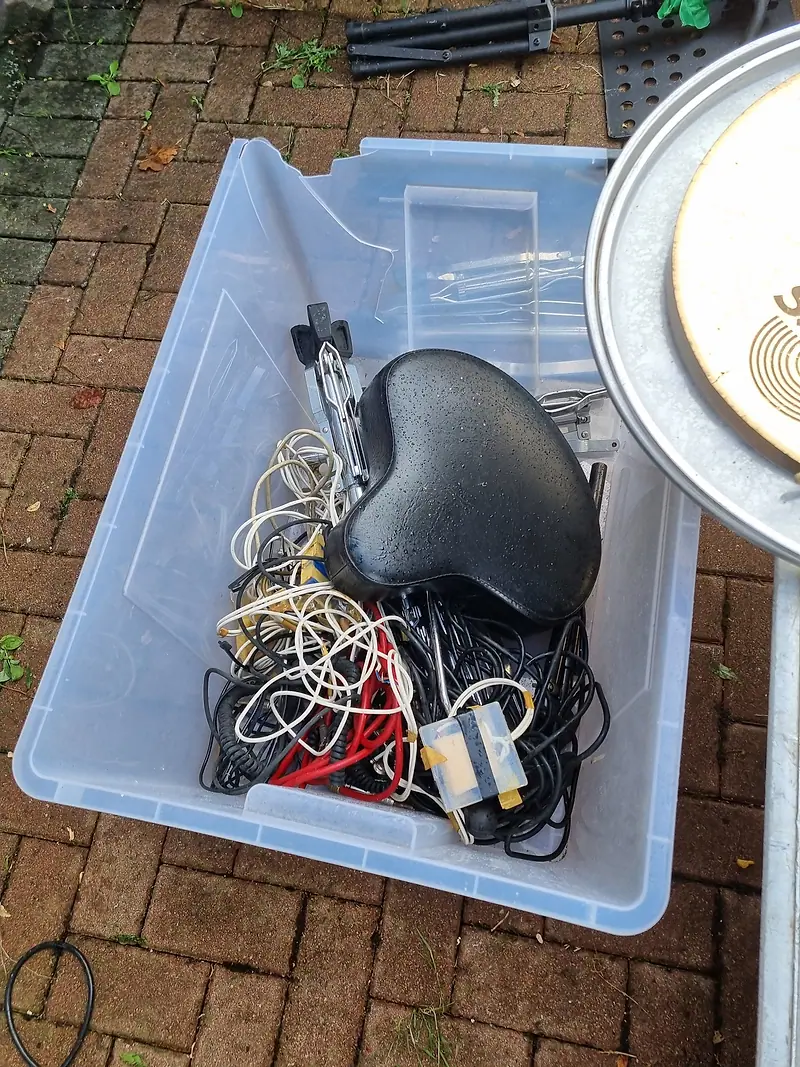 Box of old cables, chargers and electrical waste set aside for recycling