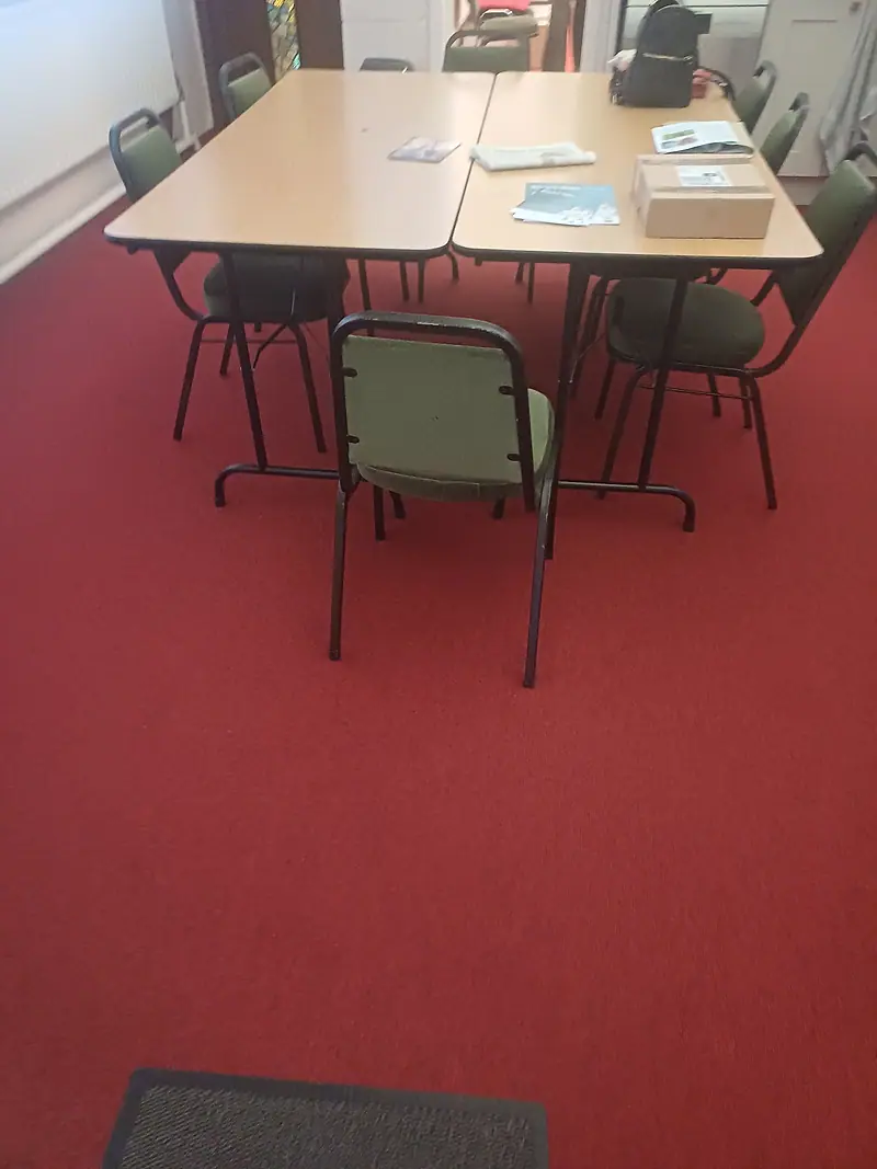 Red commercial carpet in a community room after cleaning