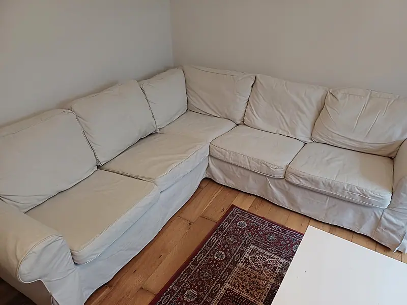 Cream fabric corner sofa on an oak floor after upholstery cleaning