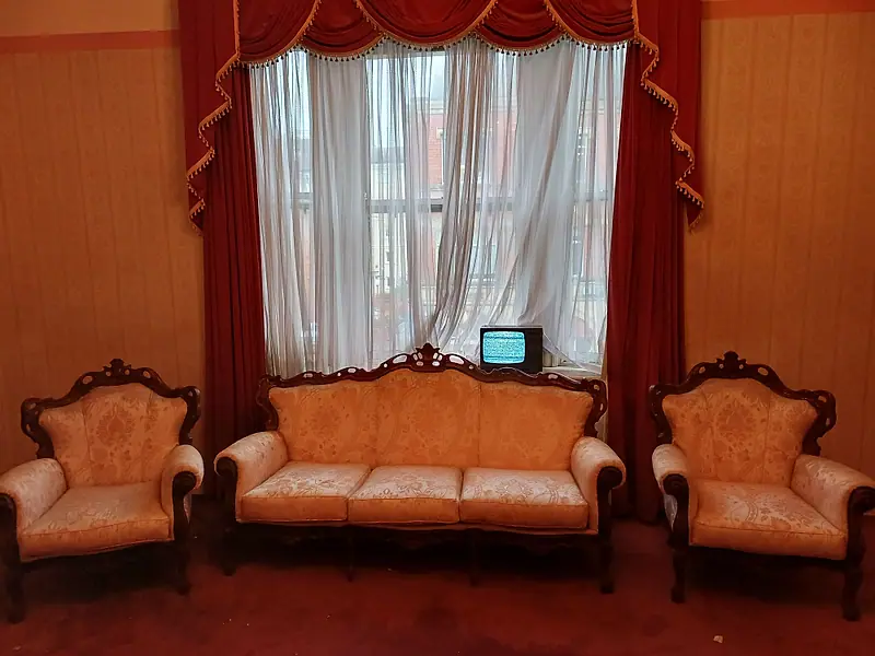 Ornate three-piece suite in cream damask with carved wooden frames before cleaning
