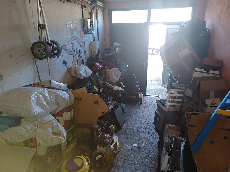 Garage packed with bags, boxes and toys before a clearance
