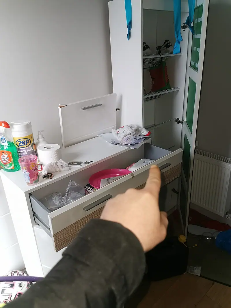 Checking an open drawer before it is cleared, so nothing important is thrown out
