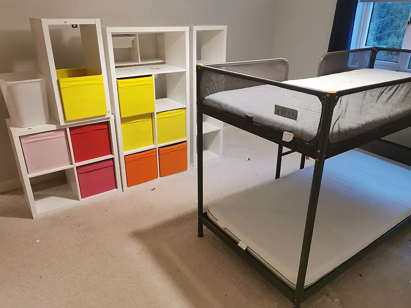 Children’s bedroom with a bunk bed and coloured storage cubes before clearance