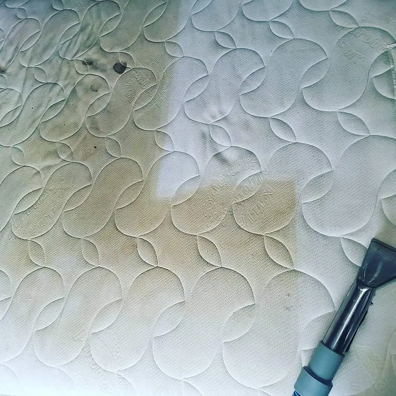 Mattress with half of a stained area cleaned away