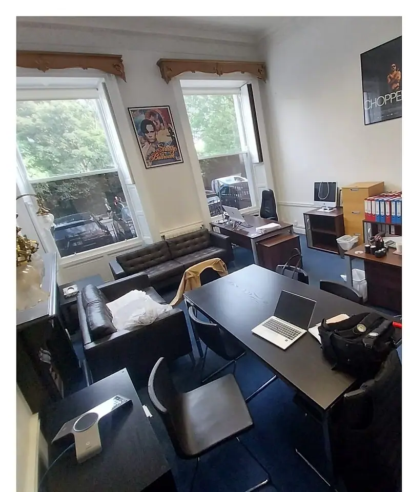 Small office with desks, a sofa and computers before an office clearance