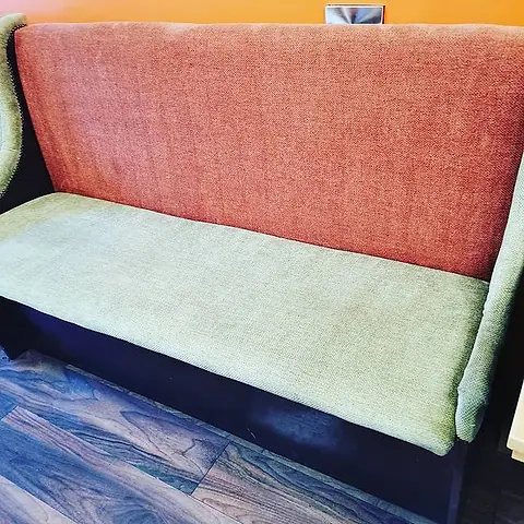 Pale green sofa seat partly cleaned, showing the difference