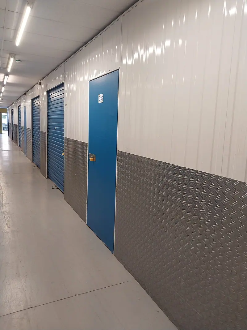 Corridor of blue self-storage unit doors in a Dublin storage facility