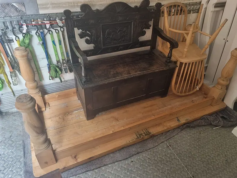 Antique bench and chairs loaded in the back of our removal truck