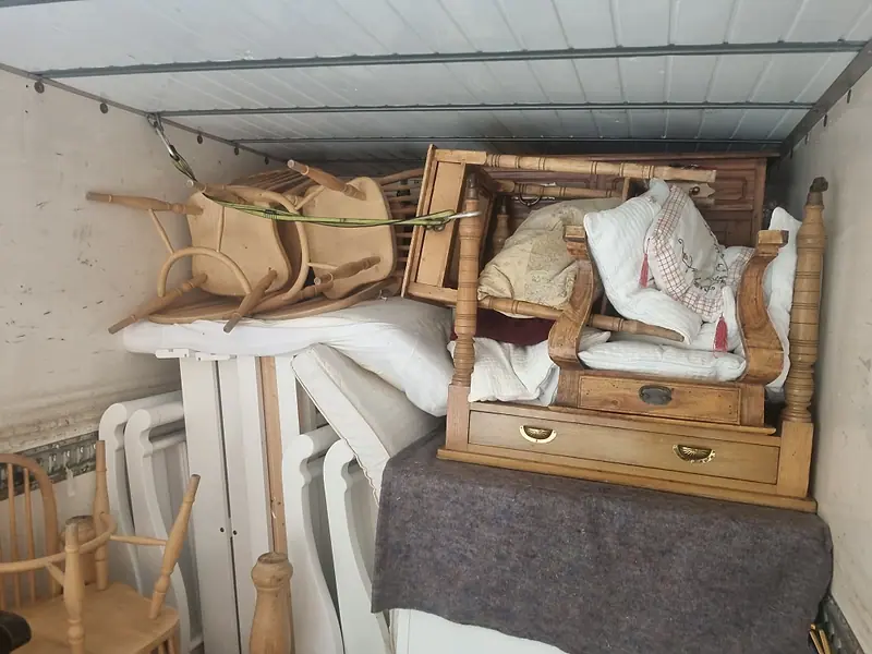 Furniture, chairs and bedding loaded and strapped inside our removal truck